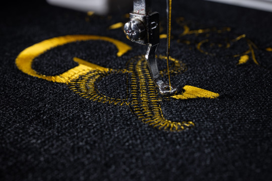 Machine,Embroidery,On,Black,Velvet,Fabric,With,Yellow,Thread.,Embroidered